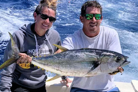 Couple holding tuna on Cape Hatteras charter trip.