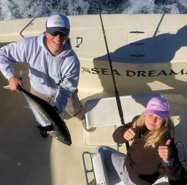Couple holding tuna on Cape Hatteras charter trip.
